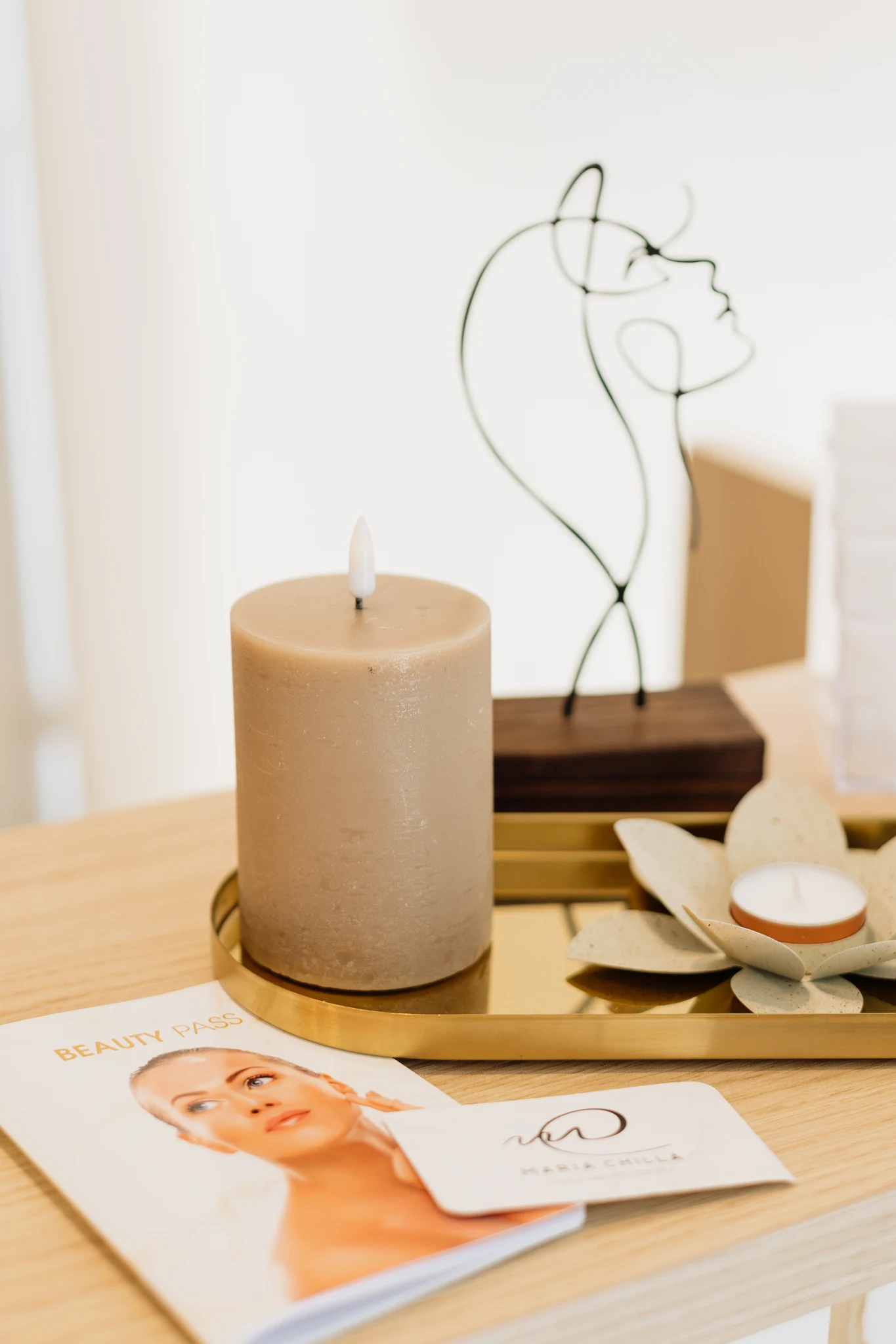 Vela decorativa sobre una bandeja dorada en un ambiente relajante